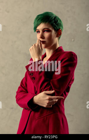 Nice green haired woman having a thoughtful look Stock Photo
