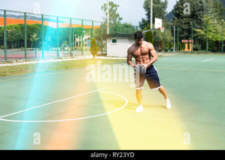 Basketball Player Bodybuilder Practicing And Posing For Basketball And Sports Athlete Concept Stock Photo