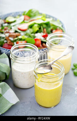 Variety of salad dressings in glass jars Stock Photo
