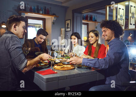 Young people eat in the restaurant in the evening.  Stock Photo