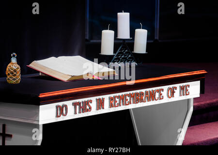 Horizontal shot of a church’s Communion Table With a Bible and Candles on it in a Christian Church. Stock Photo