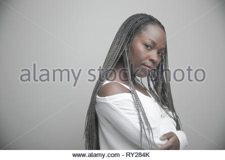 Portrait confident beautiful young African American woman with long black braids