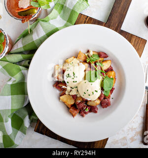 Breakfast potatoes with eggs Benedict and beef Stock Photo