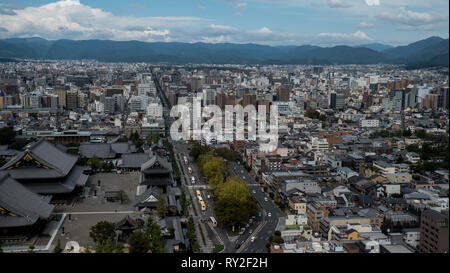 Aerial shots of the city of Kyoto. Skyscrapers and buildings expand out into the distance of the Japanese city as a stormy sky and clouds . Stock Photo