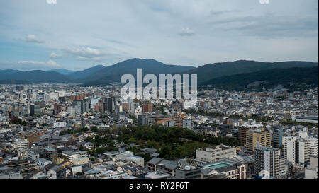 Aerial shots of the city of Kyoto. Skyscrapers and buildings expand out into the distance of the Japanese city as a stormy sky and clouds . Stock Photo