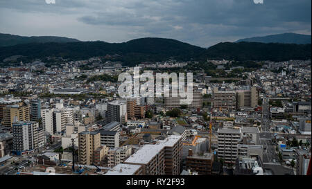 Aerial shots of the city of Kyoto. Skyscrapers and buildings expand out into the distance of the Japanese city as a stormy sky and clouds . Stock Photo