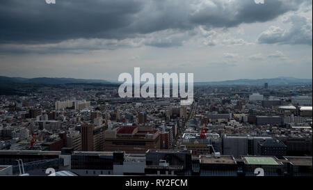 Aerial shots of the city of Kyoto. Skyscrapers and buildings expand out into the distance of the Japanese city as a stormy sky and clouds . Stock Photo