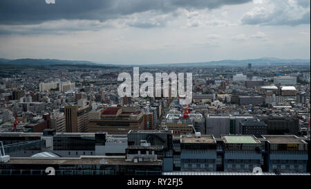 Aerial shots of the city of Kyoto. Skyscrapers and buildings expand out into the distance of the Japanese city as a stormy sky and clouds . Stock Photo