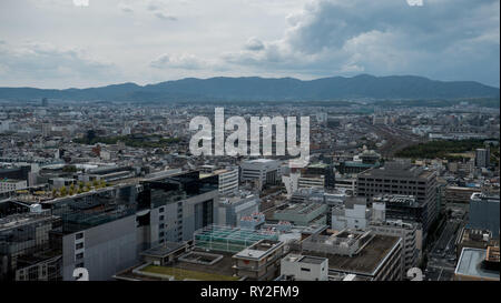 Aerial shots of the city of Kyoto. Skyscrapers and buildings expand out into the distance of the Japanese city as a stormy sky and clouds . Stock Photo