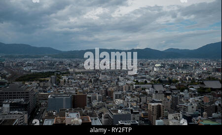 Aerial shots of the city of Kyoto. Skyscrapers and buildings expand out into the distance of the Japanese city as a stormy sky and clouds . Stock Photo