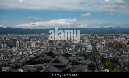 Aerial shots of the city of Kyoto. Skyscrapers and buildings expand out into the distance of the Japanese city as a stormy sky and clouds . Stock Photo