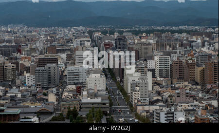 Aerial shots of the city of Kyoto. Skyscrapers and buildings expand out into the distance of the Japanese city as a stormy sky and clouds . Stock Photo