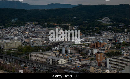 Aerial shots of the city of Kyoto. Skyscrapers and buildings expand out into the distance of the Japanese city as a stormy sky and clouds . Stock Photo