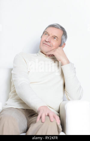 portrait of an elderly man sitting in a chair. Stock Photo