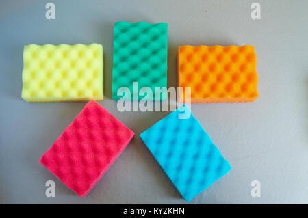 Set of sponges for home cleaning on grey background, flat lay Stock Photo