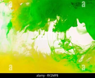 Colored paint swirling in water Stock Photo