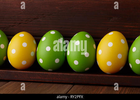 Dotted Easter eggs on wooden background Stock Photo