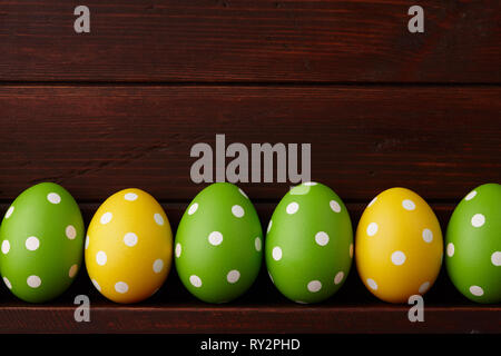 Dotted Easter eggs on wooden background Stock Photo