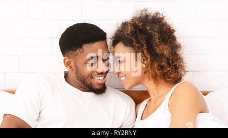 Loving black couple relaxing in bed at home Stock Photo
