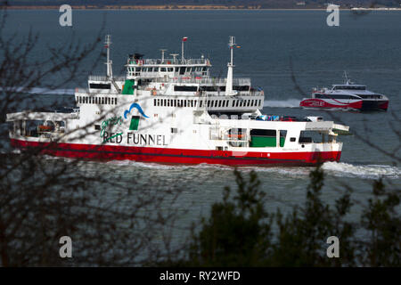 Red,Funnel,fast,passenger,car,ferry,green,deal,campaign,Cowes,Isle of Wight,England,UK, Stock Photo