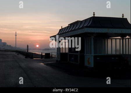 Sunrise over sea and seafront shelter, Brighton and Hove Stock Photo