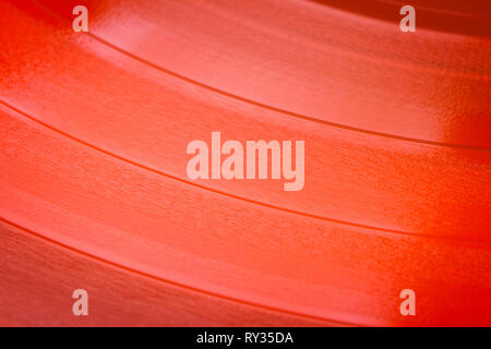 Close up of red vinyl surface. Red vinyl record texture background. Close up of vinyl LP record showing grooves Stock Photo