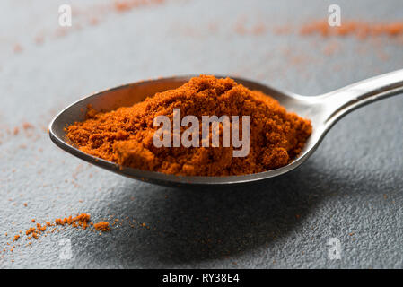 spoon of pepper ground on table macro Stock Photo