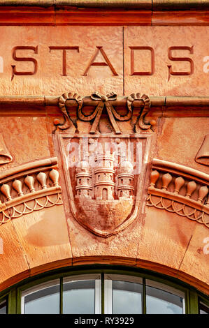 A carving above an arched window on an old sandstone building in the city centre of Helsingborg, Sweden. Stock Photo