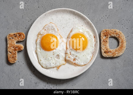 Word food written with toast letters eggs Stock Photo