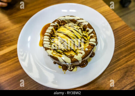 Chocolate Vanilla Ice Cream Lava Cake on a White Plate Stock Photo