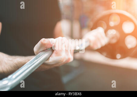 Muscular Bearded man during workout in the gym. Stock Photo