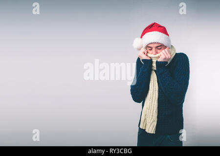 Young man in sweater feel cold over a white background Stock Photo