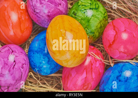 colored easter eggs in an easter basket, close up macro color photo Stock Photo