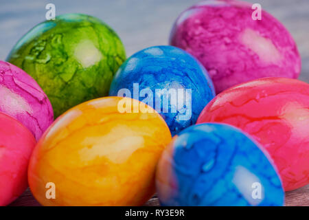 colored easter eggs close up on brown wooden surface Stock Photo