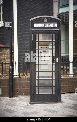 London, UK - October, 2018. An iconic black phone booth in the City of London. Stock Photo