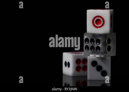 Closeup three dice stacked on dark background. Casino or business concept. Stock Photo