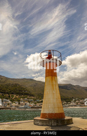 Cape Town, South Africa - the weathered harbor light at Kalk Bay harbor on the False Bay coast image in portrait format Stock Photo