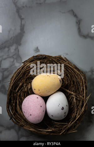 Looking down on chocolate Easter eggs laid out in nests Stock Photo