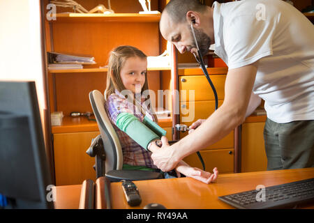 Doctor measuring a child's blood pressure Stock Photo