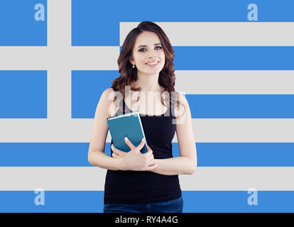 Greece concept with cute woman smiling against the Greek flag background. Travel and learn greek language Stock Photo