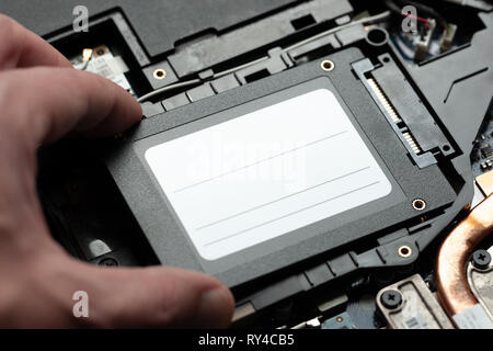 installing new solid-state drive to laptop pc. sata and power connection close up.upgrade laptop hardware.	 Stock Photo