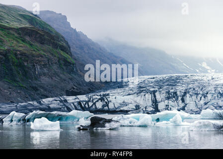 Evening landscape with ice floes in the glacial lake Fjallsarlon. Vatnajokull National Park, Iceland, Europe. Amazing tourist attraction. Art processi Stock Photo