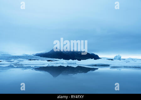 Evening landscape with ice floes in the glacial lake Fjallsarlon. Vatnajokull National Park, Iceland, Europe. Amazing tourist attraction Stock Photo