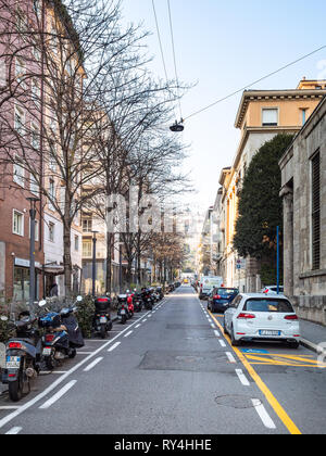 BERGAMO, ITALY - FEBRUARY 19, 2019: car and motorbike parking on street via Antonio Locatelli in Lower city. Bergamo is the capital of the Province of Stock Photo