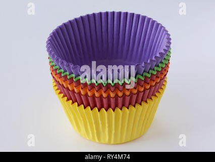 Colorful empty paper forms capsules for muffins and cupcakes on white background - baking dessert - close up on white background Stock Photo
