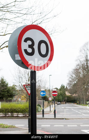 London, UK - March 2019: UK speed limit road signs showing 30 and 20 along with number of other signs related to one way, no entry and give way Stock Photo