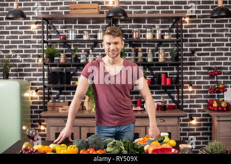 Loving handsome man feeling excited before cooking dinner for wife Stock Photo