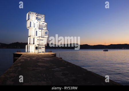 Jetty with a illuminated structure at the sunset Stock Photo
