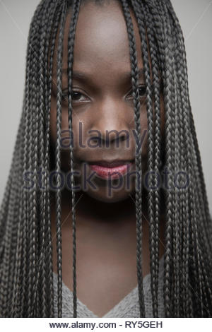Portrait confident beautiful young African American woman with long black braids Portrait confident beautiful young African American woman with long black braids