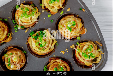 Fried potatoes with bacon and cheese, onions Stock Photo